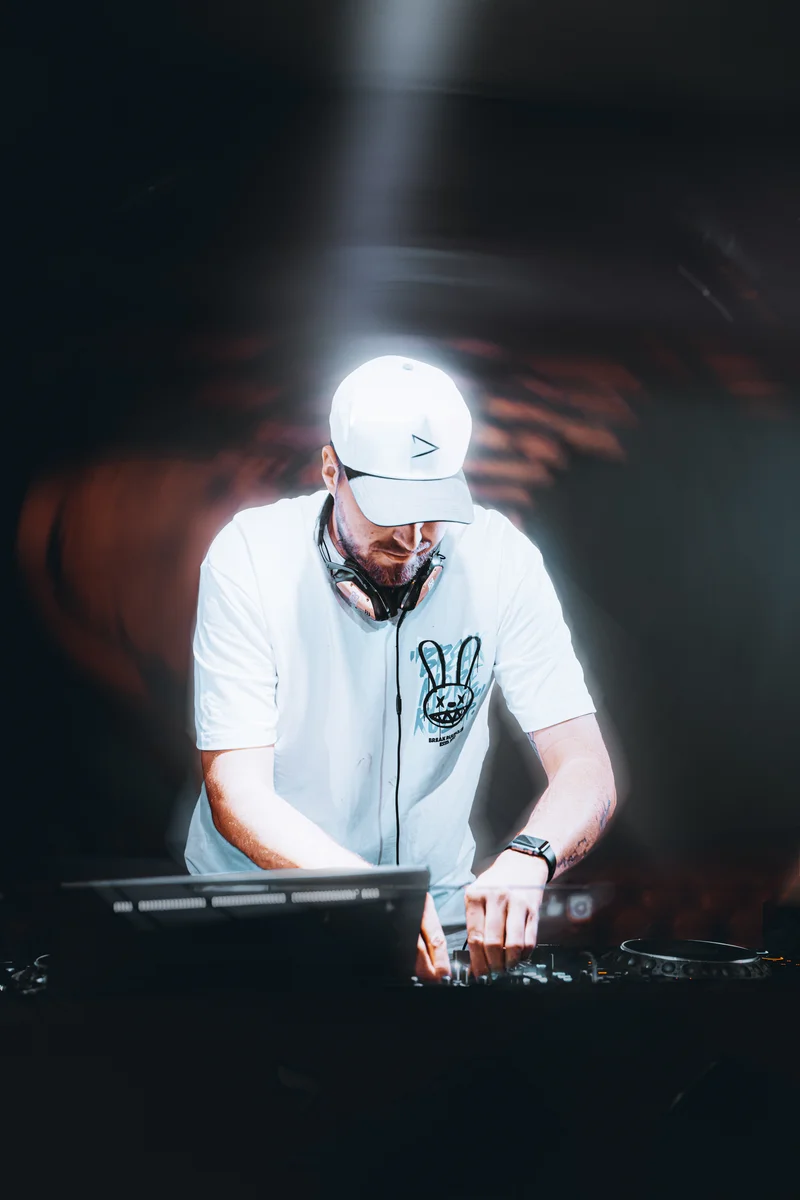 RawmanPictures - Sebastian Schiefermayr | AMP'D Drum & Bass | DJ bei der Arbeit im Club, kreative Eventfotografie, lebendige Nachtleben-Aufnahme.