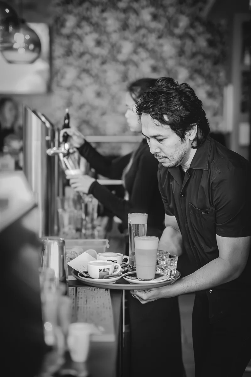 RawmanPictures - Sebastian Schiefermayr | Charity Brunch | Schwarz-Weiß-Fotografie: Barista bei der Arbeit in einem Café, detailreiche Espresso-Kultur.