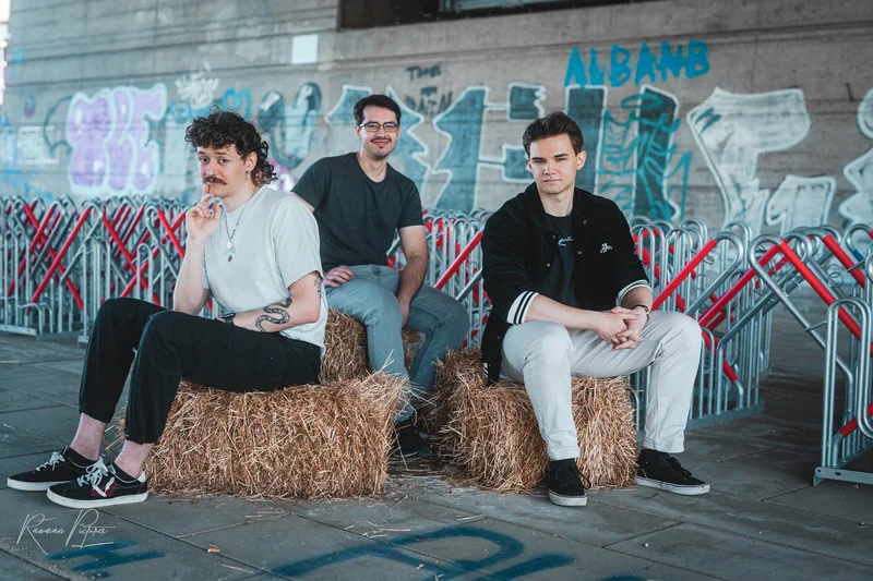 RawmanPictures - Sebastian Schiefermayr | Shooting Alex, Markus & Max | Drei junge Männer posieren kreativ auf Strohballen in urbaner Kulisse. Empfohlen für Lifestyle-Fotografie.