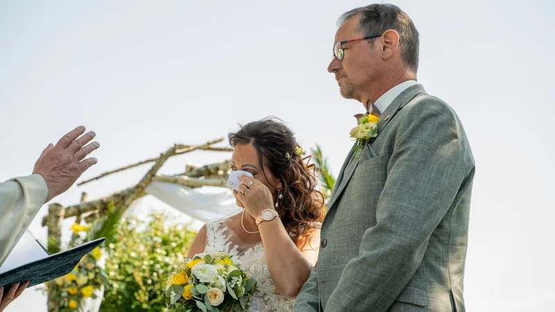 RawmanPictures - Sebastian Schiefermayr | Hochzeit Traude & Gerhard | Emotionale Hochzeitszeremonie im Freien, Brautpaar bei Gelübde unter Blumenbogen.